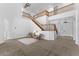Spacious living room with high ceilings, chandelier lighting, neutral carpet, and statement staircase at 3557 S Halsted Ct, Chandler, AZ 85286