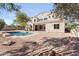 Exterior view of the home featuring a sparkling pool, brick pavers, and an expansive area for outdoor entertaining at 3557 S Halsted Ct, Chandler, AZ 85286