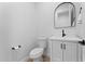 A modern powder room with a sleek mirror, stylish vanity, and fixtures at 3557 S Halsted Ct, Chandler, AZ 85286