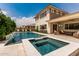 An inviting backyard featuring a pool, hot tub, covered patio, and outdoor seating for relaxation and entertainment at 3749 E Sagebrush St, Gilbert, AZ 85296