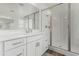 Bright bathroom featuring a walk-in shower with glass enclosure, and a white vanity with a solid surface counter at 3749 E Sagebrush St, Gilbert, AZ 85296