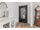 Elegant entryway featuring stylish furniture, a decorative mirror, and hardwood flooring at 3749 E Sagebrush St, Gilbert, AZ 85296