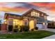 Charming two-story home with stone accents, manicured lawn, and a welcoming facade at twilight at 3749 E Sagebrush St, Gilbert, AZ 85296
