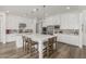 Bright kitchen with white cabinetry, stainless steel appliances, large island and bar seating at 3749 E Sagebrush St, Gilbert, AZ 85296