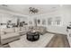Bright, open living room with hardwood floors, large sectional and view into the kitchen at 3749 E Sagebrush St, Gilbert, AZ 85296