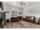 Well lit living room with large rug, desk, sofa and ceiling fan at 3749 E Sagebrush St, Gilbert, AZ 85296