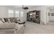 Spacious upstairs living room with a large entertainment center, comfortable seating, and natural light at 3749 E Sagebrush St, Gilbert, AZ 85296