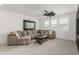 Inviting upstairs living room featuring a sectional sofa, ceiling fan, and a view to the outside at 3749 E Sagebrush St, Gilbert, AZ 85296