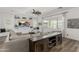 Open living room boasts a ceiling fan, stylish built-ins, plush sectional and large windows at 3749 E Sagebrush St, Gilbert, AZ 85296