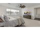 Bright main bedroom featuring a comfortable bed, large windows, and a view to the outside at 3749 E Sagebrush St, Gilbert, AZ 85296