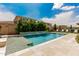 A luxurious pool with a serene waterfall feature and elegant tile accents surrounded by lush greenery at 3749 E Sagebrush St, Gilbert, AZ 85296