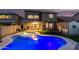 Backyard at dusk with pool, turf lawn, trampoline, shed, and covered patio at 3882 W Goldmine Mountain Dr, San Tan Valley, AZ 85144