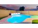The home has a night view of backyard with pool, lights, and privacy wall at 3882 W Goldmine Mountain Dr, San Tan Valley, AZ 85144