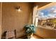 Relaxing balcony area with ambient lighting overlooking the community with privacy curtain and seating at 3882 W Goldmine Mountain Dr, San Tan Valley, AZ 85144