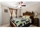 Comfortable bedroom featuring ceiling fan, traditional headboard, and natural light from window at 3882 W Goldmine Mountain Dr, San Tan Valley, AZ 85144