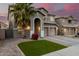 Charming home featuring a well-manicured yard, desert landscaping, and a welcoming arched entryway at 3882 W Goldmine Mountain Dr, San Tan Valley, AZ 85144