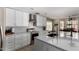 Bright kitchen featuring white cabinets, a mosaic backsplash, stainless steel appliances, and a large island at 3882 W Goldmine Mountain Dr, San Tan Valley, AZ 85144