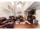 Spacious living room with vaulted ceilings, hardwood floors, and comfortable leather furniture at 3882 W Goldmine Mountain Dr, San Tan Valley, AZ 85144