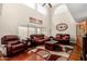 Spacious living room with vaulted ceilings, hardwood floors, and comfortable leather furniture at 3882 W Goldmine Mountain Dr, San Tan Valley, AZ 85144