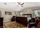 Spacious main bedroom with ceiling fan, wood-look floors, warm colors, sitting area and accent rug at 3882 W Goldmine Mountain Dr, San Tan Valley, AZ 85144