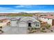 Aerial view of the home showcasing the landscaped yard and neighborhood lake at 40610 W Desert Fairways Dr, Maricopa, AZ 85138