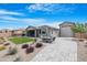 Landscaped backyard with a patio, artificial grass, and a view of the home at 40610 W Desert Fairways Dr, Maricopa, AZ 85138