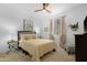Bedroom with bright walls, ceiling fan and a bed with decorative pillows, creating a serene atmosphere at 40610 W Desert Fairways Dr, Maricopa, AZ 85138