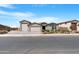 Charming home featuring a three-car garage and an inviting desert landscape, showcasing its appealing curb appeal at 40610 W Desert Fairways Dr, Maricopa, AZ 85138
