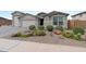 Close up of a house with a beautifully xeriscaped front yard, perfect for low-maintenance living at 40610 W Desert Fairways Dr, Maricopa, AZ 85138
