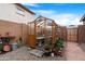 Backyard greenhouse with pea gravel and stone flooring at 40610 W Desert Fairways Dr, Maricopa, AZ 85138