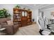 Cozy home office space featuring a spacious bookcase and comfortable chair, ideal for relaxation at 40610 W Desert Fairways Dr, Maricopa, AZ 85138