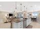 Island kitchen view, with granite countertops, seating, stainless appliances, and open floorplan at 40610 W Desert Fairways Dr, Maricopa, AZ 85138
