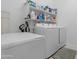 Well-organized laundry room with washer, dryer, deep freezer, and plenty of storage space at 40610 W Desert Fairways Dr, Maricopa, AZ 85138