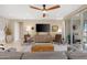 Open floor plan living room with a ceiling fan and plenty of space for entertaining at 40610 W Desert Fairways Dr, Maricopa, AZ 85138