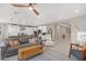 Bright, open-concept living room with contemporary decor, tile floors, and natural light at 40610 W Desert Fairways Dr, Maricopa, AZ 85138
