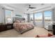 Spacious main bedroom with a king-size bed, ceiling fan, and view of the community at 40610 W Desert Fairways Dr, Maricopa, AZ 85138