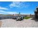 Backyard patio featuring stone flooring and lake views at 40610 W Desert Fairways Dr, Maricopa, AZ 85138