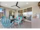 Covered patio featuring comfortable seating, lake view, and ceiling fan at 40610 W Desert Fairways Dr, Maricopa, AZ 85138