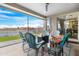 Covered patio featuring comfortable seating, lake view, and tile flooring at 40610 W Desert Fairways Dr, Maricopa, AZ 85138