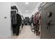 Expansive walk-in closet with ample hanging space, shelving, and secure storage for clothing and accessories at 40610 W Desert Fairways Dr, Maricopa, AZ 85138