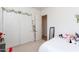 Bright bedroom featuring a large closet with white doors and neutral carpeting at 4313 N 161St Ave, Goodyear, AZ 85395