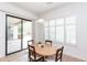 Bright breakfast nook with modern light fixture, shutters and sliding glass doors leading to an outdoor living space at 4313 N 161St Ave, Goodyear, AZ 85395