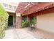 Inviting front entrance featuring a covered patio, stone accents, and a cozy seating area at 4313 N 161St Ave, Goodyear, AZ 85395
