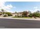 Beautiful home exterior with lush landscaping, a two-car garage, and desert foliage at 4313 N 161St Ave, Goodyear, AZ 85395