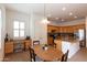Spacious kitchen with tile flooring, wood cabinetry, stainless appliances and an eat-in breakfast nook with an office space at 4313 N 161St Ave, Goodyear, AZ 85395