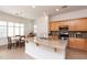 Bright kitchen featuring granite countertops, stainless appliances, and an island with sink and breakfast bar at 4313 N 161St Ave, Goodyear, AZ 85395