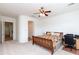 Spacious main bedroom features an arched doorway, ceiling fan, neutral carpet, and en-suite bathroom at 4313 N 161St Ave, Goodyear, AZ 85395
