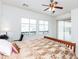 Bright main bedroom featuring neutral carpet, a ceiling fan, and plantation shutters for ample natural light at 4313 N 161St Ave, Goodyear, AZ 85395