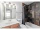 Modern bathroom featuring a bathtub with striking tile and a vanity with bright lighting at 4445 E Coconino St, Phoenix, AZ 85044