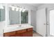 This bathroom has a vanity with cabinet storage, a glass-enclosed shower, and neutral paint at 4445 E Coconino St, Phoenix, AZ 85044